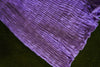 Close-up of purple cotton bloomers showing all-over elastic smocking and softly ruffled leg openings.