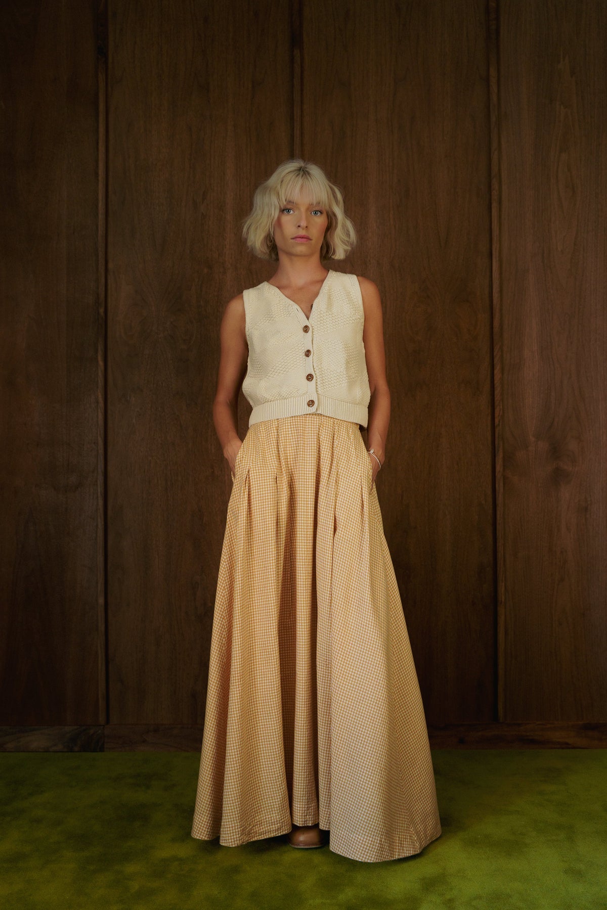 Front view of the Alli Marye Rosemary Skirt in CandyCorn gingham, styled with a cream knit vest.
